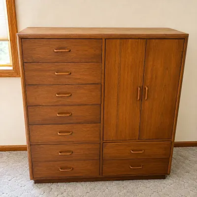 Sale Photo Thumbnail #170: This Gentleman's Chest features a combination of 9 spacious drawers and a wardrobe area, providing versatile storage options. Crafted from rich wood with a warm, medium-brown finish, it showcases clean lines and sturdy construction typical of vintage desi