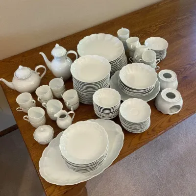 Sale Photo Thumbnail #126: This elegant Kaiser Porzellan dinnerware set from Bad Staffelstein, Bavaria, dates back to 1960-1970. Crafted from fine white porcelain, the set includes a variety of pieces such as teapots, cups, saucers, plates, and serving dishes. The porcelain is mark