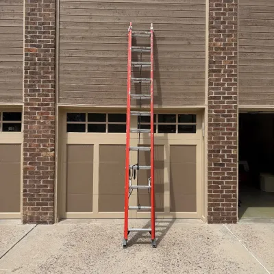 Sale Photo Thumbnail #207: This Werner extension ladder offers a total length of 24 feet and a maximum working length of 21 feet, making it ideal for a variety of professional and heavy-duty tasks. Constructed from non-conductive fiberglass, it ensures safety when working near elec