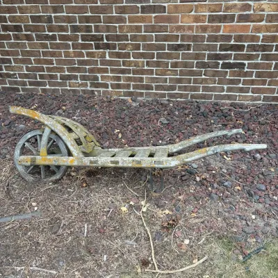 Sale Photo Thumbnail #31: This vintage barrel trolley features a classic rustic design crafted entirely from wood. Measuring 65 inches from handle to wheel and 18 inches wide, it showcases a sturdy wooden frame and a single wooden wheel with spokes. The trolley exhibits weathered 
