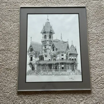Sale Photo Thumbnail #93: Framed architectural print by James E. Coyle depicting the highly ornate Carson Mansion in Eureka, California. The detailed black-and-white composition highlights the mansion’s elaborate Victorian architecture, including its tower, gables, porches, deco