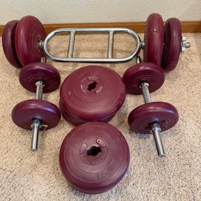 Sale Photo Thumbnail #219: This DP Fit For Life Weight set offers a versatile 110 lbs total weight capacity, perfect for a range of strength training exercises. The set features maroon-colored weight plates made from durable materials, each plate marked with precise weight indicato