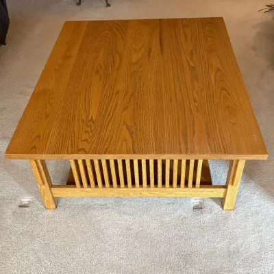 Sale Photo Thumbnail #163: This Mission Style coffee table is crafted from solid wood, showcasing a warm natural finish that highlights the wood grain beautifully. Measuring 16.5 inches tall, 44 inches wide, and 36.5 inches deep, it offers a spacious rectangular surface perfect for
