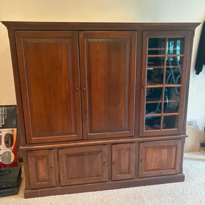Sale Photo Thumbnail #192: This elegant entertainment center is crafted from traditional cherry wood, showcasing a rich, warm finish that enhances any living space. Measuring 69 inches tall, 72 inches wide, and 27 inches deep, it offers ample storage with multiple drawers, cabinets