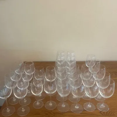 Sale Photo Thumbnail #273: This collection features a total of 33 assorted wine glasses, suitable for both red and white wine. Each glass is clear and made of glass material, with an approximate height of 7 inches and a rim diameter of around 3 inches, providing a versatile size fo