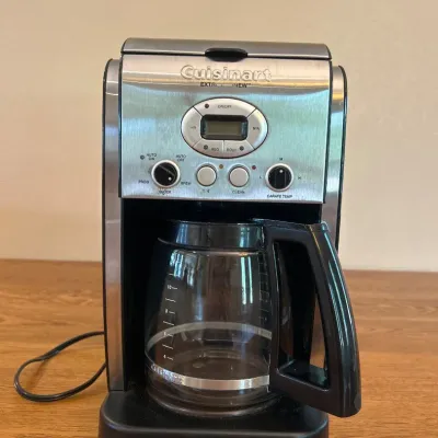 Sale Photo Thumbnail #252: This Cuisinart Extra Brew Coffee Maker features a sleek and durable stainless steel exterior, combining modern style with functionality. It includes a clear glass carafe with a black handle, a user-friendly control panel with an LCD screen, and simple but