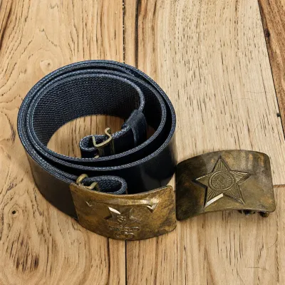 Sale Photo Thumbnail #14: Lot includes a vintage Soviet-era adjustable military belt with brass-tone buckle, along with an additional loose Soviet military buckle.

The belt buckle features a raised five-pointed star with hammer-and-sickle emblem positioned above an anchor, a desi