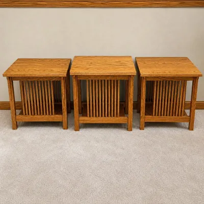 Sale Photo Thumbnail #162: This set includes three beautifully crafted Mission style side tables made from oak wood, showcasing a classic design with vertical slat sides and rich wood grain. The set comprises two larger tables measuring 24" x 22" x 26" and one slightly smaller tabl