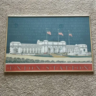 Sale Photo Thumbnail #101: Framed architectural poster depicting Union Station in Washington, D.C., created by noted architectural illustrator Carlos Diniz (1928–2001) and marked “DINIZ ’88 / Carlos Diniz Associates.”

The design commemorates Union Station’s 1908–1988 a
