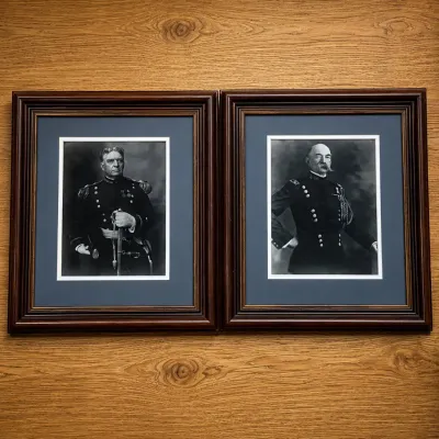 Sale Photo Thumbnail #38: This set features two striking black and white military portraits, each housed in a classic dark wooden frame with layered detailing. The portraits depict formal military figures dressed in uniform, presenting a historical and dignified aesthetic. The fra