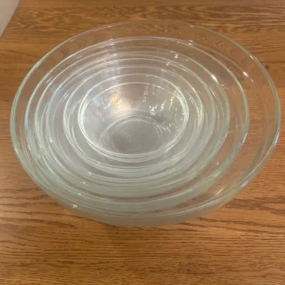 Sale Photo Thumbnail #256: This elegant set of 6 nesting glass bowls by Duralex is made in France, known for its high-quality tempered glass. The clear glass design allows for versatile use in any kitchen or dining setting. Each bowl varies in size, perfectly nesting for compact st