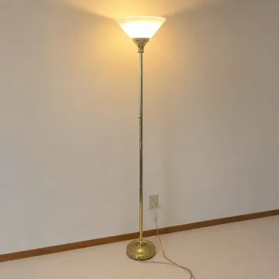 Sale Photo Thumbnail #226: This torchiere floor lamp features a classic design with a brass finish, providing a warm and inviting glow to any room. The lamp includes a frosted glass shade that diffuses light softly upwards, creating ambient lighting ideal for living rooms or readin