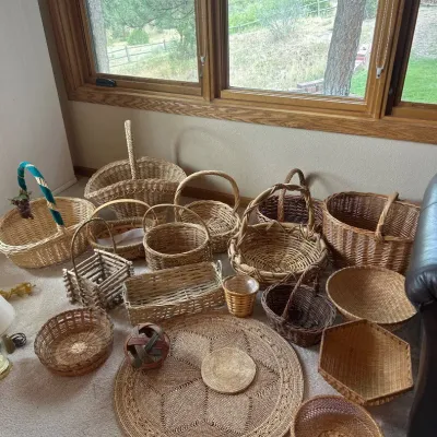 Sale Photo Thumbnail #159: This unique Wicker Collection features a diverse assortment of handwoven baskets and decorative items crafted from natural wicker materials. The collection includes various basket shapes such as picnic baskets, round and rectangular trays, and a rustic tw