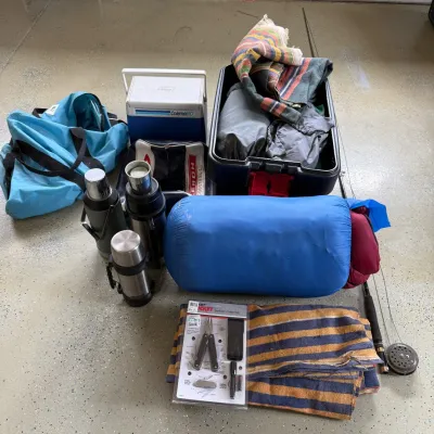 Sale Photo Thumbnail #203: This camping and sporting goods set features a variety of essential outdoor equipment, including three stainless steel thermoses with insulated caps for hot or cold beverages. The kit also includes a durable, colorful striped blanket, a blue sleeping bag,