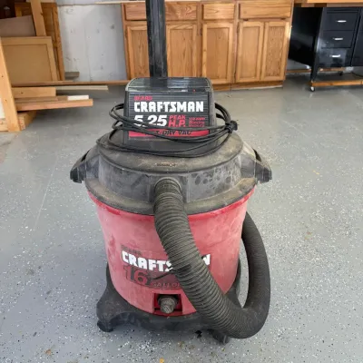 Sale Photo Thumbnail #322: This Craftsman wet/dry vacuum cleaner features a powerful 5.25 peak horsepower motor capable of handling tough cleaning tasks. Designed with a large 8 gallon tank, it is suitable for both wet and dry debris, making it ideal for workshop or household use. 