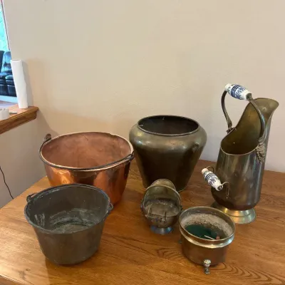 Sale Photo Thumbnail #156: A diverse set of assorted metal canisters featuring a variety of shapes, sizes, and materials including brass, copper, and tin. Highlights include a tall brass canister with elegant white and blue ceramic handles, a hammered copper bowl with a rustic pati