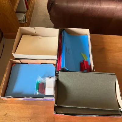 Sale Photo Thumbnail #306: This set includes a variety of file folders in multiple vibrant colors such as blue, green, red, yellow, pink, and black, stored neatly in original cardboard boxes. It features different sized folders with both standard and dark green options, along with 