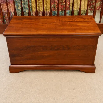 Sale Photo Thumbnail #74: This Lexington Quilt Chest #833-652 is a beautifully crafted wooden storage chest made in the U.S.A. It features a traditional design with sturdy construction and a warm wood finish, perfect for adding a touch of classic elegance to your home. The chest o