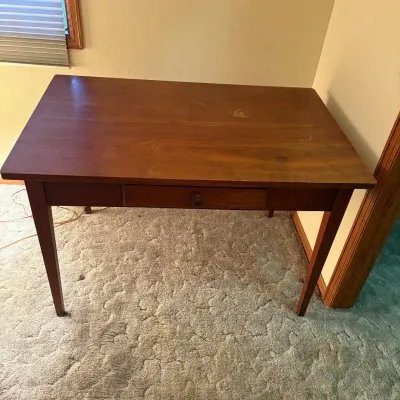 Sale Photo Thumbnail #168: This Craftsman style writing desk features a solid wood construction with a warm finish, perfect for adding a classic touch to your workspace. It measures 30 inches tall, 47 inches wide, and 30 inches deep, providing ample surface area. The desk includes 