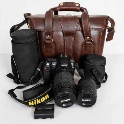 Sale Photo Thumbnail #20: Nikon D50 digital SLR camera bundle with two Nikon AF Nikkor zoom lenses and multiple carrying cases.

Includes:

● Nikon D50 DSLR camera body

● Nikon AF Nikkor 70-300mm f/4-5.6G zoom lens

● Nikon AF Nikkor 28-80mm f/3.3-5.6G zoom lens

● Nikon 