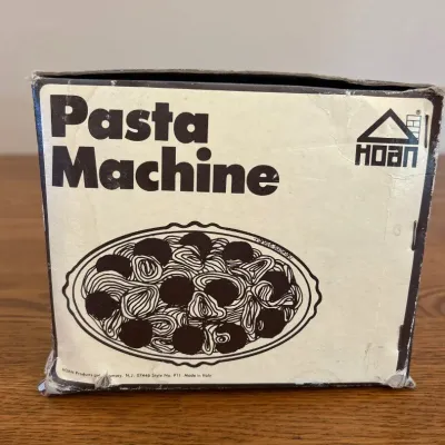 Sale Photo Thumbnail #243: This vintage Hoan Pasta Machine is a durable and efficient kitchen tool designed for creating perfect homemade spaghetti. Made in Italy, it features a heavy-duty construction and a 7-thickness adjustment for customizable pasta results. The machine is simp