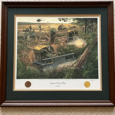 Sale Photo Thumbnail #52: Framed limited-edition military print titled “Engineers Clear the Way” by noted historical artist Dale Gallon. The dramatic Vietnam War scene depicts U.S. Army Combat Engineers using armored Caterpillar bulldozers to clear dense jungle, accompanied by