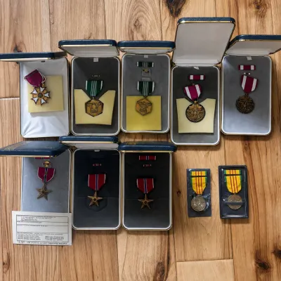 Sale Photo Thumbnail #62: Collection of U.S. military decorations and service medals from the estate of a former U.S. Army officer and battalion commander. All medals are housed in their original presentation cases except for one of the two Vietnam Service Medals, with correspondi
