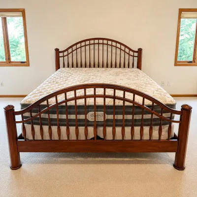 Sale Photo Thumbnail #175: This king size bed set features a sturdy wooden frame with elegantly curved headboard and footboard, standing 56.5 inches and 39.5 inches tall respectively. The set includes a comfortable Beautyrest mattress and matching box springs. The rich wood finish 