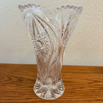 Sale Photo Thumbnail #144: This Nachtmann Bleikristall Florenz vase stands 8.5 inches tall and is crafted from high-quality lead crystal. Featuring intricate cut glass patterns, including starburst and swirling designs, it reflects light beautifully for an elegant display. The vase