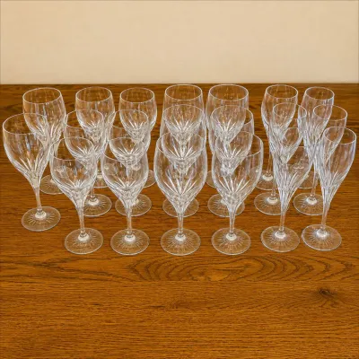 Sale Photo Thumbnail #134: This set of Turning Point wine glasses features a classic and elegant cut crystal design, perfect for enhancing any dining experience. Each glass stands approximately 7 inches tall with a bowl diameter of about 2.5 inches, making them ideal for serving wi