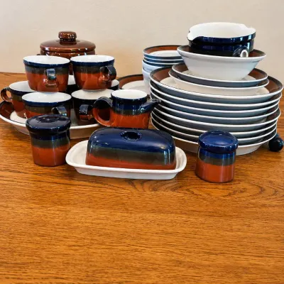 Sale Photo Thumbnail #128: This complete Mikasa Potters Art dinnerware set, designed by Ben Seibel and made in Japan, features the distinctive Fire Song pattern. The set includes various plates, cups, saucers, and serving pieces all showcasing a rich brown and navy color scheme acc
