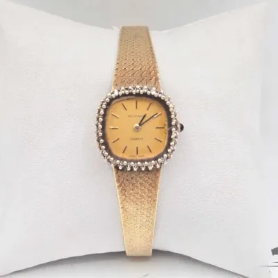 1103 14kt gold movado watch with diamonds