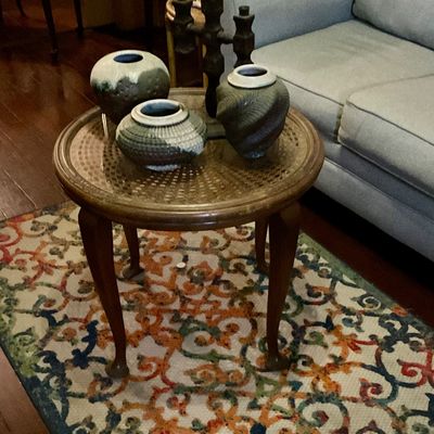 Vases on antique French. Rattan topped table with glass top