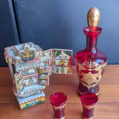 Traditional Rajasthani Kaavad on the left, and a Venetian Ruby Red Glass Kiddush set on the right