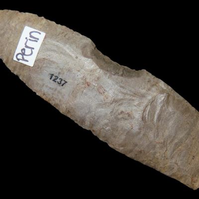 Sale Photo Thumbnail #231: Amazing 4" Paleo Fluted Clovis found in Western Tennessee. Nice long example with a great spoke shave on one edge. Nicely ground basal edges. Ex Greg Perino, Ex Joey Ellis.