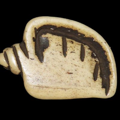 Sale Photo Thumbnail #419: Amazing Pre-Columbian Conch Shell Effigy Bead, Mexico. Carved from Bone, highly polished. Drilled for suspension.