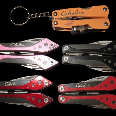 Sale Photo Thumbnail #967: Lot of 5 New Cabela's Brand Pocket Knife Multi Tools, Pliars, Knife, Flat & Phillips Screwdriver, Scissors, Can Opener, Saw. New & Unused. Orange one has a flashlight.