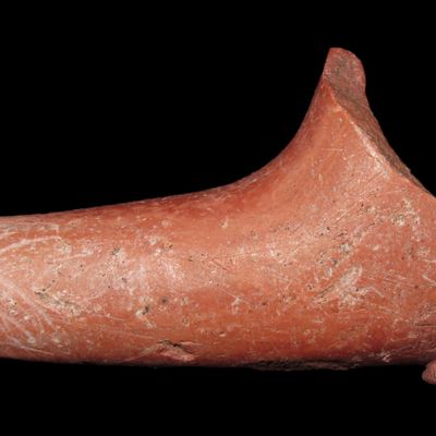 Sale Photo Thumbnail #166: 2 5/8" Catlinite Elbow Pipe with a Nice Raised Lip around the stem and a Raised Knob decoration on the bottom of the Bowl. Ancient damage to the bowl that is evenly patianted. Great Example.