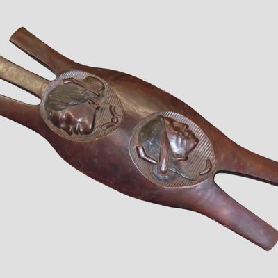 Sale Photo Thumbnail #756: Large 38" Iroquois Style Hand Carved Wooden Shield with Indian Chief Busts, very detailed design, handle intagrated into the back side. Each Indian has a Pipe tucked in its hair bun. Nice Wall Hanger for theMan Cave! Made from a Single piece of wood. Nice