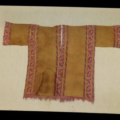 Sale Photo Thumbnail #409: Rare Pre-Columbian Inca / Nazca Original Fabric Shirt, custom mounted on 40" x 31" frame. Nice rare artifact. Recovered in Peru.