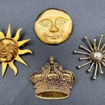 Gold-toned Brooch Lot Featuring A “Sun Of Knowledge” Alva Studios Brooch 