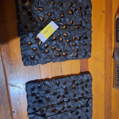 cast iron piece with open scroll work and handles.