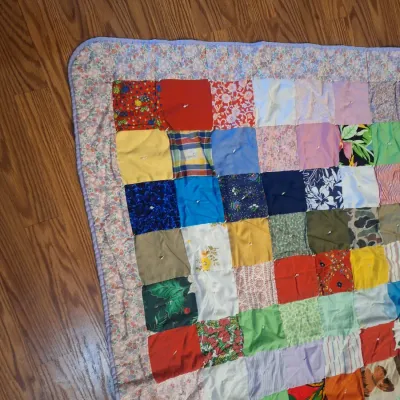 hand made lap quilt with writing on back side