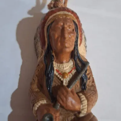 Ornament- Native American Style Seated Hunter Warrior Figurine with Feather Headdress & Rifle