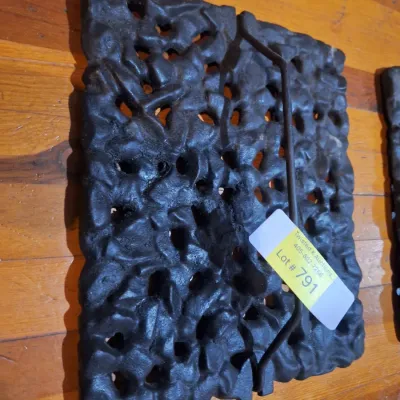 cast iron piece with open scroll work and handles.