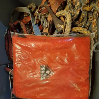 tub with assorted tack and a feed bucket