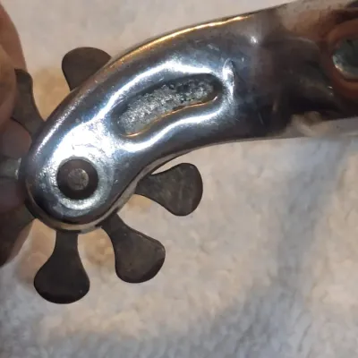 western riding spurs with brown tooled-leather spur straps