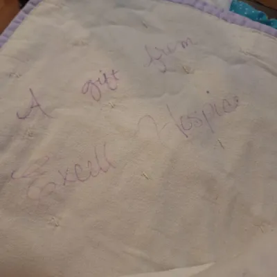 hand made lap quilt with writing on back side