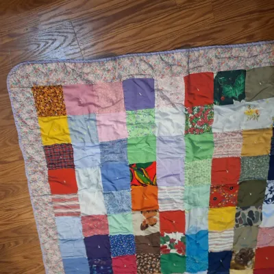 hand made lap quilt with writing on back side