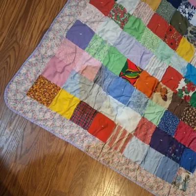 hand made lap quilt with writing on back side